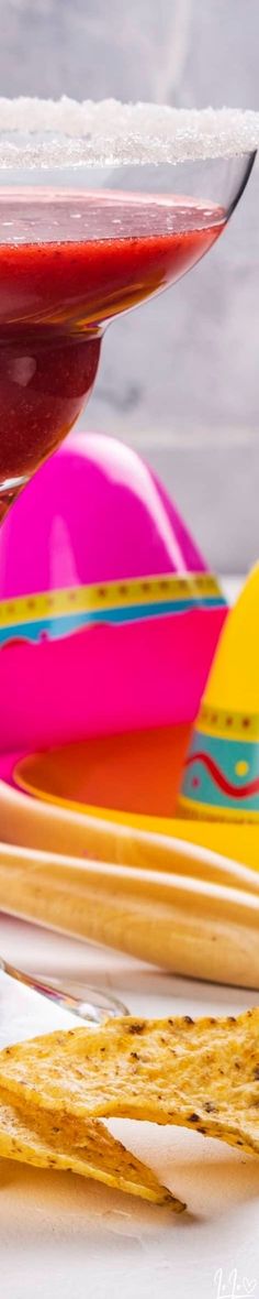 colorful plates and utensils are sitting on a white tablecloth next to each other