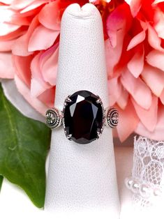 5ct. Black Onyx Cubic Zirconia (CZ) Solid Sterling Silver RingDragon Design#D133 This lovely sterling silver filigree ring is set with a stunning 5ct. Black Onyx Cubic Zirconia (CZ) gemstone solitaire. This oval cut gem is 14mm by 10mm. The ring sits 8mm off the finger. The inside of the band is marked 925 for solid sterling silver. Notice the detailed design of the silver filigree setting and band. This is an exquisite rendition of a Gothic ring. The Renaissance filigree has amazing elegance. Black Rings With Gemstone Accents As Gift, Black Rings With Gemstone Accents For Gift, Black Oval Jewelry With Gemstone Accents, Black Oval Gemstone Accent Jewelry, Black Cubic Zirconia Crystal Ring For Gift, Gothic Ring, Gothic Rings, Detailed Design, Sterling Silver Filigree