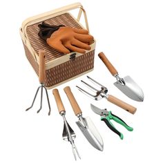 gardening utensils and garden gloves in a wicker basket on white background with clippings