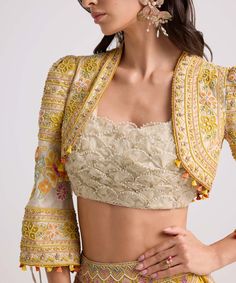 Elevate your ensemble with this ivory chanderi bolero jacket, adorned with intricate contrast cordwork and delicate beadwork. This piece exudes sophistication and style, adding a touch of elegance to any outfit. Embroidered Blouse Piece With Cape Sleeves For Wedding, Fitted Choli With Resham Embroidery And Cape Sleeves, Floral Embroidered Choli With Cape Sleeves For Parties, Party Choli With Cape Sleeves And Floral Embroidery, Party Choli With Floral Embroidery And Cape Sleeves, Fitted Silk Nehru Jacket For Reception, Silk Fitted Nehru Jacket For Reception, Fitted Silk Nehru Jacket With Chikankari Embroidery, Elegant Front Open Choli For Wedding