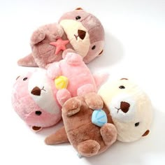 four stuffed animals laying on top of each other