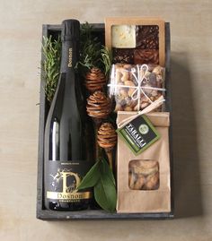 a bottle of wine and some snacks in a box