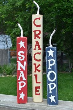 three red, white and blue signs are in the grass