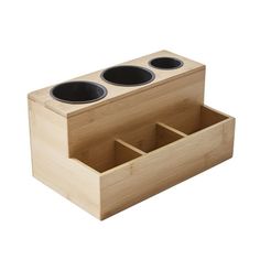 a wooden box with three cups in the bottom and one on the inside, sitting next to each other