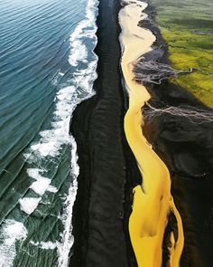 an aerial view of the black sand beach in iceland with yellow water flowing down it