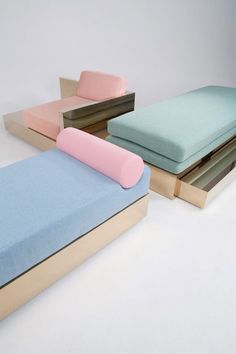 three different colored mattresses sitting next to each other