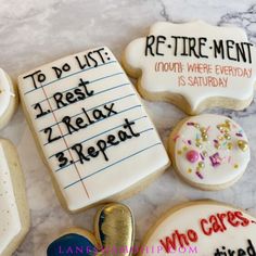 decorated cookies with writing on them sitting on a table