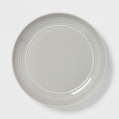 an empty white plate on a white surface