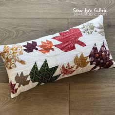 a quilted pillow sitting on top of a wooden floor