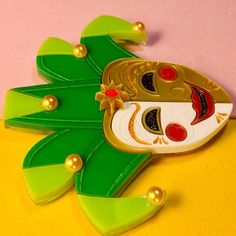 Product Details Handmade item Length: 7 Centimeters; Width: 6.5 Centimeters Materials: Plastic Made to Order To pay homage to the wonderful tradition of the Venice Carnival, we have created these brooches inspired by the Jester's mask. Two colors are available, green and blue. Maintenance: Acrylic is a fairly delicate material and can scratch easily. Please, use only a microfiber cloth to clean it (like the one used for eyeglass lenses) and keep your jewels away from heat sources and chemical su Artistic Green Brooch For Gift, Artistic Green Brooches For Gifts, Artistic Multicolor Brooches For Gift, Artistic Multicolor Brooches As Gift, Traditional White Brooch For Gift, Jester Mask, Venice Carnival, Acrylic Brooch, Italian Traditions