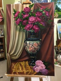 a painting of flowers in a vase on a easel