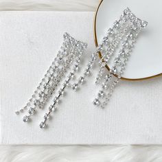 Our Boa Rhinestone Duster Earrings are statement making earrings that sparkle and shine with cascading layers of rhinestones. Perfect for when you want to add that final touch that will catch the spotlight, these glamorous earrings are perfect for parties, music festivals, and dancing through the night! About 5 inches long 925 Silver Post - can be a bit flexible This is a special occasion item = FINAL SALE