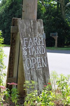 an old wooden sign that says farm stand open