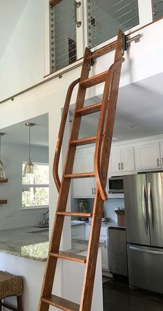 a ladder leaning up against the wall in a kitchen