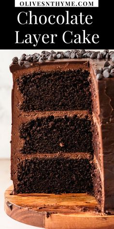 a slice of chocolate layer cake on a wooden platter