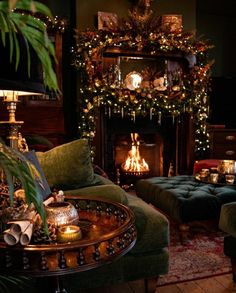 a living room filled with furniture and a fire place covered in christmas garlands next to a fireplace