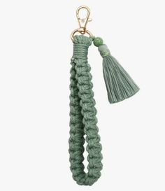 a green keychain with a tasselle hanging from it's end