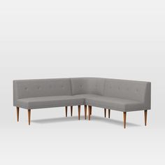 a corner couch with two legs and a back rest