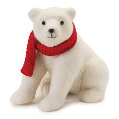 a white stuffed polar bear wearing a red scarf