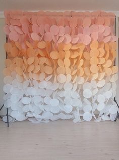 an orange and white curtain with circles on it in front of a wooden flooring area