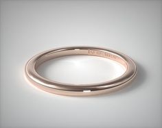 a rose gold wedding ring with the word love written on it's side, in front of a white background