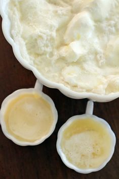 three cups filled with ice cream on top of a wooden table