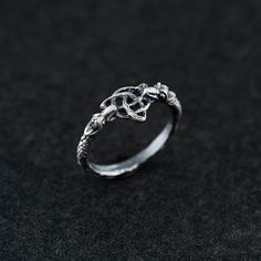 This sterling silver Celtic dragon knot ring is a stunning symbol of connection, eternity, and mystical energy. The intricate knotwork design, featuring a blend of Celtic motifs and a subtle dragon element, evokes ancient traditions and mythical strength. Perfect for fans of Celtic, fantasy, and nature-inspired jewelry, this ring combines the charm of knotwork with the fierce symbolism of the dragon. Handcrafted with meticulous attention to detail, this ring is oxidized to highlight its textures Boho Wedding Bands, Celtic Knot Jewelry, Celtic Dragon, Knot Ring, Unique Wedding Bands, Nature Inspired Jewelry, Stylish Gifts, Celtic Knot, Pretty Jewellery