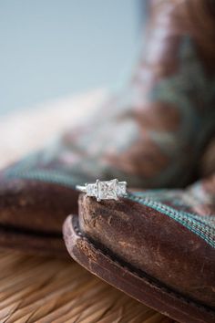 an engagement ring sitting on top of a pillow