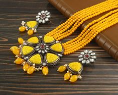 This is a stunning handmade necklace perfect for high end Jewelry Collector, a keeper in Traditional Vintage Indian/Pakistani Bridal jewelry and a Luxury Gift for your Daughter, Sister or Wife on Wedding or Anniversary. Perfect for any type of occasions, weddings And celebrations and a beautiful & memorable gift for weddings and special occasions. -Item Code:- L2405 -Yellow Beaded Rajwada Necklace Set with Earrings. -Designer necklace multi layered Yellow beaded mala with Kundan pendant. -Gold Plated Set with Kundan Stones which shine like Polki Diamonds. -Metal: Black oxidized brass -Earrings are 65mm long and 27mm wide -Push Back Earrings -Necklace length with pendant 12" approx excluding dori/cord -Quantity:- One Necklace Set Please see more different designs here:- https://www.etsy.com Luxury Kundan Jewelry In Yellow Gold, Polki Diamond Necklace, Yellow Beaded Necklace, Pakistani Bridal Jewelry, Necklace Set With Earrings, High End Jewelry, Designer Necklace, Pakistani Jewelry, Vintage Indian