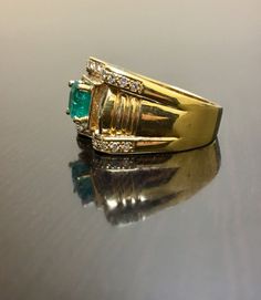 DeKara Designs Classic Handmade Art Deco Oval Emerald and Diamond Ring. This ring was entirely handmade, anyone lucky enough to buy this ring will truly appreciate the workmanship and the beauty of this piece of art. Metal- 18K Yellow Gold, .750. Size- 8. FREE SIZING Measurements- Ring is 13.3 MM in the front and tapers down to 4.5 MM in the back. Stones- 1 Emerald Cut Colombian Emerald 1.00 Carat, 26 Round Diamonds, 14 Baguette Diamonds, F-G Color VS2 Clarity 0.80 Carats. Entirely Handmade Art Art Deco Style Emerald Ring With Round Cut, Art Deco Round Emerald Ring, Heirloom Diamond Cut Emerald Ring For Anniversary, Exquisite Emerald Ring With Diamond Cut, Gold Emerald Cluster Ring With Brilliant Cut, Formal Fine Jewelry Couple Rings With Prong Setting, Emerald Cut Gemstone Signet Ring For Anniversary, Formal Gold Rings With Emerald, Oval Jewelry With Vvs Clarity For Marriage