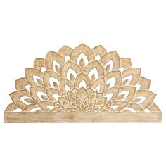 a wooden shelf with a carved flower design on it