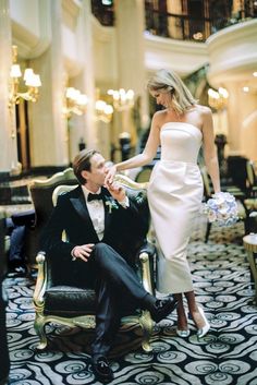 a man in a tuxedo sitting next to a woman in a white dress