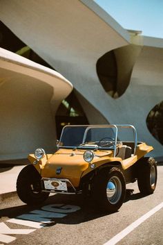 a yellow jeep is parked in front of a building