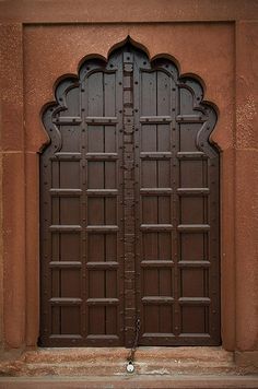 an ornate doorway with two large wooden doors