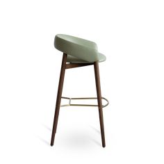 an upholstered stool with wooden legs and a green leather seat, on a white background