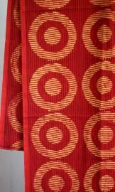 a red and gold cloth with circles on it