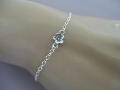 This dainty bracelet has a 5mm cherry blossom link in the center of sterling silver figure eight chain. The clasp is a sterling silver spring ring that can hook into any loop of the chain, making the bracelet adjustable up to 8". This bracelet is dainty and can break when tugged. Dainty Silver Chain Bracelet With Lobster Clasp, Dainty Adjustable Jewelry For Spring, Dainty Adjustable Spring Jewelry, Adjustable Dainty Spring Jewelry, Dainty Nickel-free Silver Chain Bracelet, Spring Silver Bracelet Jewelry, Dainty Spring Jewelry With Adjustable Chain, Spring Dainty Jewelry With Adjustable Chain, Dainty Adjustable Flower Chain Bracelet