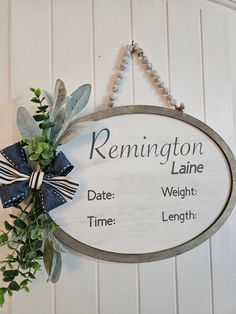 a sign hanging on the side of a white wall that says rennington lane