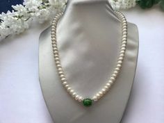 Freshwater Pearl with Green Jade Barrel design Necklace  Material : Freshwater Pearl, jade & silver plated clasp Pearl shape: button shape Pearl Size: 8-9mm Jade shape : 13mm x10mm  Clasp : good luck symbol silver plated clasp Necklace Length : 16",18 " & 20" Packing: silk Bag Green Round Pearl Necklace For Gift, Elegant Green Jade Pearl Necklace, Formal Green Pearl Necklace With Round Beads, Green Pearl Necklace For Formal Occasions, Elegant Jade Pearl Necklace For Gift, Jade Design, Luck Symbol, Good Luck Symbols, Silk Bag