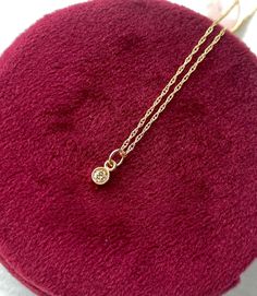 Wow! This diamond has so much sparkle. It is a genuine directly imported White colored  diamond and is simply set in a solid 14kt gold bezel setting and hangs from a solid 14kt gold chain. Please choose either a 16 inch chain or 18 inch chain from the drop down menu. If you want just the charm and No chain-choose '0'  Details: - Genuine White fully faceted diamond. Directly imported. Measures 2.5mm round and weights 0.09 carats. Very clear-bright and top quality. This price is amazing for a diam Dainty Diamond Necklace With Bezel Setting, Diamond Birthstone Necklace With Bezel Setting As Gift, Rose Gold Dainty Diamond Necklace With Birthstone, Dainty Round Charm Necklace With Diamond Accents, Dainty Rose Gold Diamond Necklace With Birthstone, Dainty Birthstone Necklace With Single Diamond, Delicate Diamond Necklace With Bezel Setting As Gift, Dainty Diamond Charm Necklaces, Dainty Diamond Charm Necklace With Round Pendant