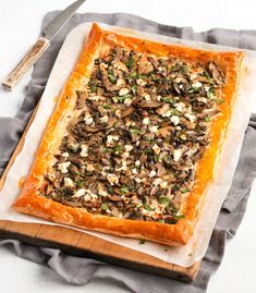 puff pastry mushroom tart on a cutting board