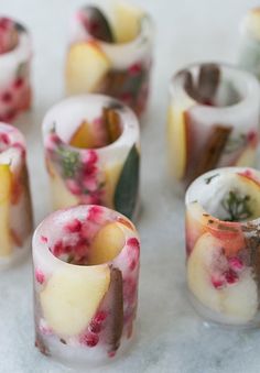 several candles are decorated with flowers and leaves