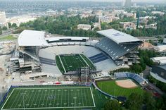 an aerial view of a football stadium with the field being built in front of it