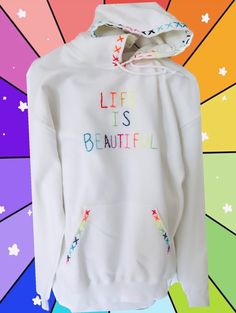 Hand embroidered rainbow capital letters stitched life is beautiful beaded hoodie White Hoodie With Custom Embroidery For Fall, White Hoodie With Embroidered Graphics For Fall, White Hoodie With Embroidered Text For Fall, White Embroidered Sweatshirt For Spring, White Sweatshirt With Custom Embroidery For Spring, White Hoodie With Embroidered Text For Winter, White Embroidered Hoodie For Fall, White Hoodie With Custom Embroidery For Winter, Winter White Hoodie With Embroidered Text