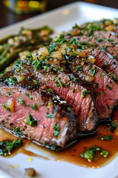 steak and asparagus on a white plate with brown sauce, garnished with parsley