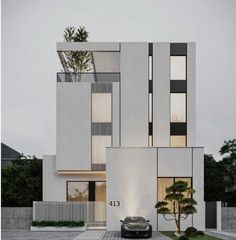 a car is parked in front of a modern house