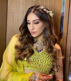 a woman wearing a yellow outfit and jewelry