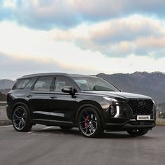 a black suv parked on the side of a road