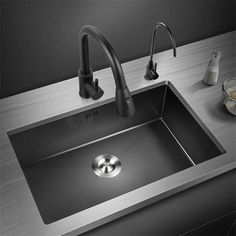 a kitchen sink with faucet and soap dispenser