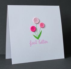 a greeting card with two pink buttons and the words feel better